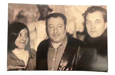 a black and white photo of a man and two women