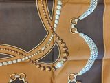 an image of a scarf with beads and tassels on it