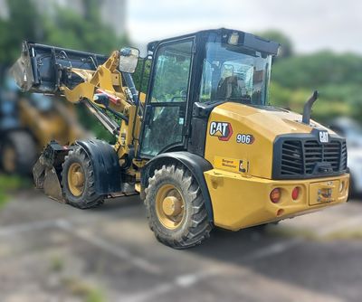 a yellow tractor that is parked in a parking lot
