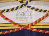 yellow, blue, red, and white sailor ' s hat with a horse drawn on it