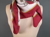 a white mannequin torso with a red and white scarf on it