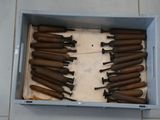 a lot of guns in a box on the floor