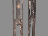 two metal sculptures of a man and a woman on a gray background