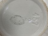 a close up of a white vase with writing on it
