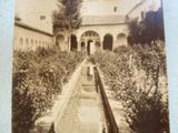 an old photo of a building with a fountain in front of it