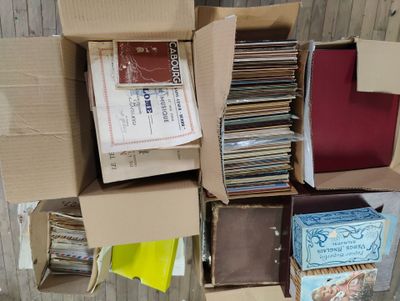 a box full of cds and other records on the floor