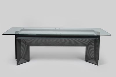 an image of a table with a glass top and a metal base
