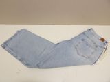 jeans on a white table with a brown tag on it