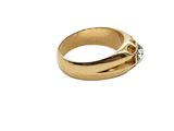 a close up of a gold ring with a diamond in the middle