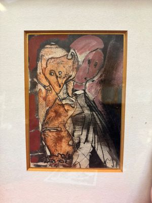 painting of a woman and a cat in a frame on a table