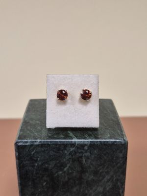 un gros plan sur une paire de boucles d'oreilles posées sur un bloc de marbre