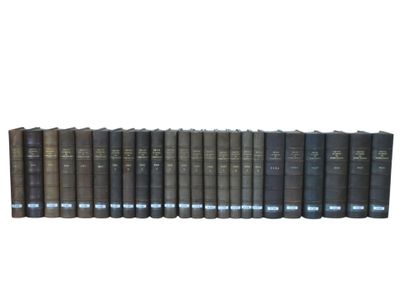 a row of books sitting on top of each other on a white surface