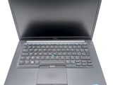an open laptop computer sitting on top of a white surface