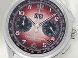un gros plan d'une montre-bracelet au cadran rouge
