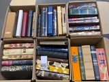 many books in a box on the floor