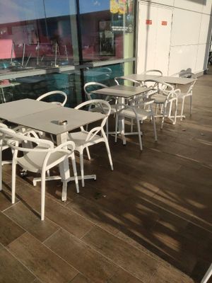 des tables et des chaises devant une fenêtre donnant sur la ville