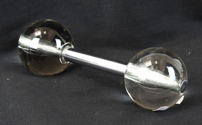 a glass wine glass with a metal handle on a black background