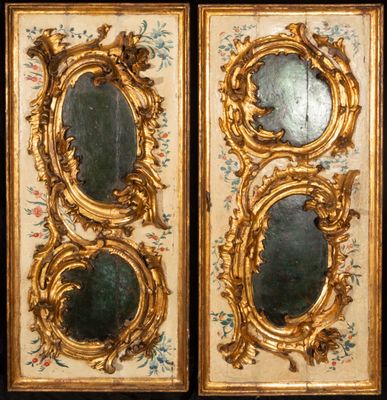two gold framed mirrors with floral designs on them on a black background