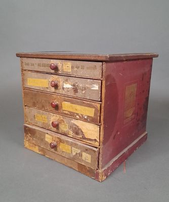 a small wooden box with five drawers on top of it