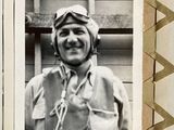 a black and white photo of a man in a pilot ' s uniform