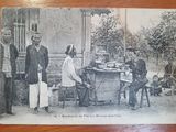 an old black and white photo of a group of people sitting around a table