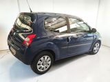 a picture of a small blue car parked in a garage
