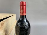 a bottle of wine sitting next to a wooden box