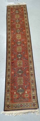 rug on the floor is red and tan with a pattern