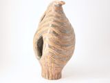 a vase that is sitting on a white surface