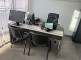 a desk with two computer monitors and a laptop on it