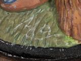 a ceramic figurine of a man and a woman sitting on a rock