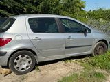 a silver car that is parked on the side of the road
