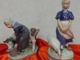 deux figurines représentant une femme et un chien posées sur une table