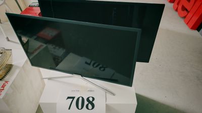 un téléviseur à écran plat posé sur un meuble dans un magasin