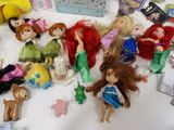 a lot of dolls that are sitting on a table