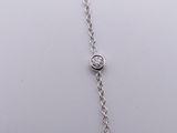 silver plated chain with a single crystal on a white background