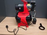 a red blower sitting on top of a wooden table