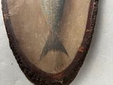a painting of a fish on a piece of wood