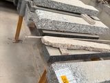 many pieces of granite sitting on a wooden table