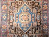 an antique persian rug with a blue and red design