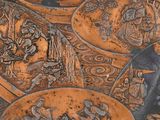 many plates with different designs on them sitting on a table