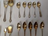 a lot of silver spoons and spoon spoons on the table