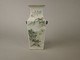 a vase with a painting on it sitting on a table