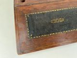 a wooden box with a black and gold design on it