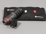 a close up of a flashlight on a black bag on a table