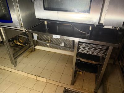 a kitchen with a stove and a microwave on the counter