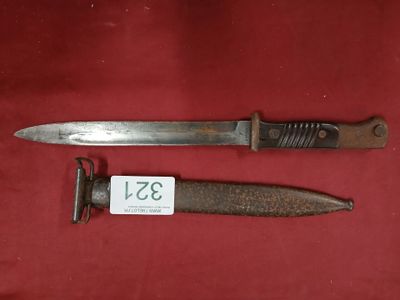 an old knife and a razor on a red cloth