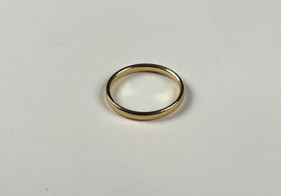 a close up of a gold ring on a white surface