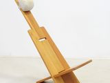 an image of a wooden chair with a white ball on top of it