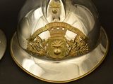 a silver helmet with a gold emblem on it